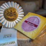 a wedge of Moshannon a tangy manchego with a farm show ribbon