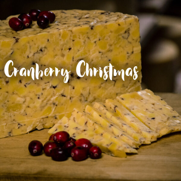 a sliced wedge of our cranberry and cardamom flavored cheddar