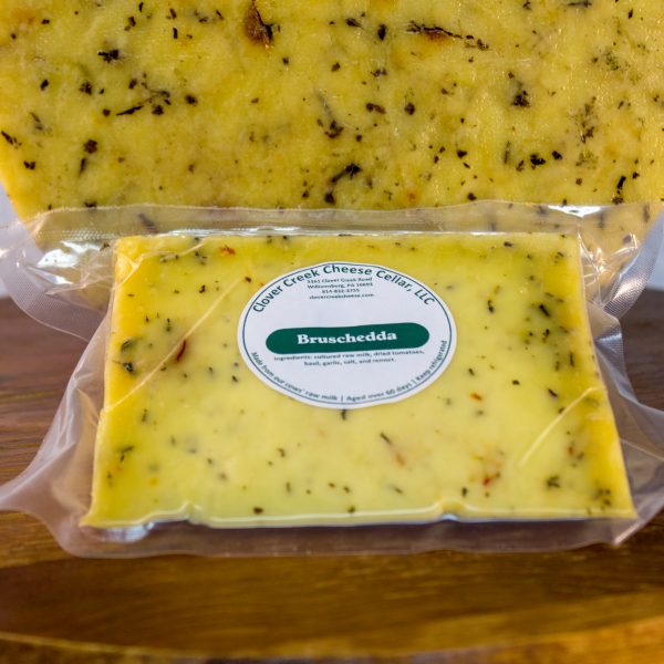 a wedge of our basil, garlic and dried tomato flavored cheddar