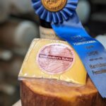 A wheel and wedge of Winemakers Select, blue ribbon winner at the 2025 Farm Show