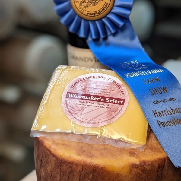 A wheel and wedge of Winemakers Select, blue ribbon winner at the 2025 Farm Show