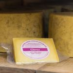 a wedge and wheels of Clover cheddar