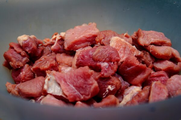 raw beef cubes on blue ceramic bowl