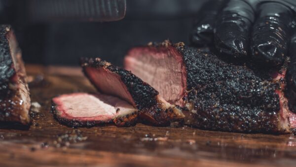 sliced beef brisket on brown wooden chopping board